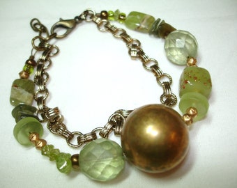 Green and Brass Beaded Bracelet - Brass focal bead - Variety of green glass beading and small brass beads