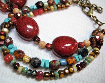 MultiColor Beaded Bracelet *3 Strands of color - Pretty Orange Oval Ceramic beads * Aqua blue & more accent beads - Tassel and bead dangle
