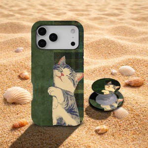 May include: A rectangular smartphone case and a circular phone grip featuring a graphic illustration of a cream and grey tabby cat with closed eyes, set against a dark green background with a subtle plaid pattern on one side of the design.