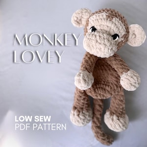 May include: A plush, crocheted monkey lovey in shades of brown and cream. The monkey has a soft, textured appearance with a detailed face and floppy limbs. Text on the image reads "MONKEY LOVEY" and "LOW SEW PDF PATTERN".