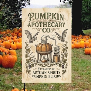 May include: A rectangular garden flag with a cream-coloured background featuring the text PUMPKIN APOTHECARY CO. PREPARERS OF AUTUMN SPIRITS PUMPKIN ELIXIRS. The design includes a central pumpkin still, two flying bats, and decorative vine borders.