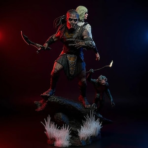 May include: A detailed statue featuring a warrior with a menacing expression, holding a curved blade and a smaller figure with a torch. A woman stands behind the warrior. The figures are on a dark base with white grass.