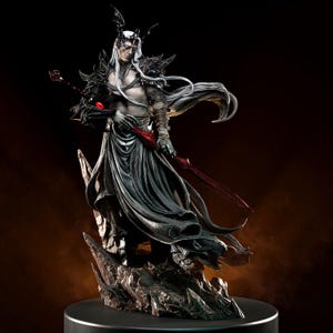 May include: A detailed figurine of a fantasy character with long white hair, wearing dark armour and a flowing black robe. The figure holds a red sword and a staff with a red gem. The statue stands on a rocky base.