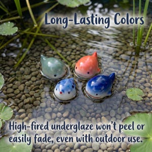 May include: Four small ceramic whale figurines in light green, orange, white with blue spots, and dark blue floating in water. The text reads: Long-Lasting Colors. High-fired underglaze won't peel or easily fade, even with outdoor use.