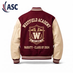 May include: A maroon varsity jacket with cream-colored sleeves, featuring a ribbed collar, cuffs, and hem with white stripes. The back displays a crest with the text Westfield Academy, Est. 2003, and Varsity - Class of 2024 in white lettering.