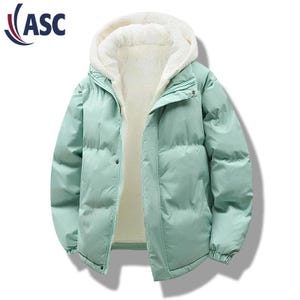 May include: A light green puffer jacket with a white, fluffy, hooded lining. The jacket has a zipper closure and a button closure. The logo "ASC" is in the upper left corner. This winter coat is designed for warmth and comfort.
