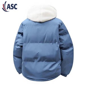 May include: A light blue puffer jacket with a white, fluffy hood. The jacket has a smooth, quilted texture and a full-length zipper. The logo "ASC" is in the upper left corner. This winter coat is designed for warmth and style.