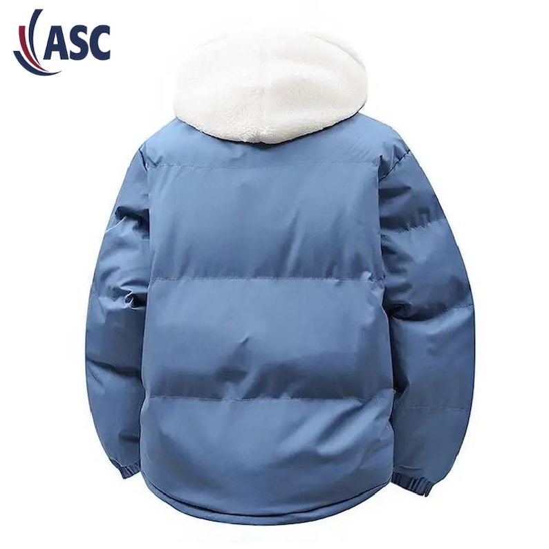 May include: A light blue puffer jacket with a white, fluffy hood. The jacket has a smooth, quilted texture and a full-length zipper. The logo "ASC" is in the upper left corner. This winter coat is designed for warmth and style.