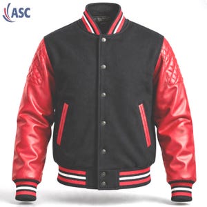 May include: A black varsity jacket featuring red quilted leather sleeves, a stand-up collar, and a front button closure. The ribbed cuffs and hem display horizontal stripes in black, white, and red. Two vertical welt pockets are on the front.