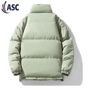 May include: A light green puffer jacket with a high collar. The jacket has a quilted design and ribbed cuffs. The logo "ASC" is visible in the upper left corner. This winter coat is designed for warmth and style.