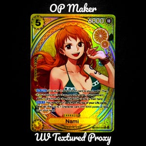 May include: A holographic trading card featuring the character Nami from the Straw Hat Crew. The card has a gold and green colour scheme with the text "OP Maker" and "UV Textured Proxy". The card has a power level of 6000.