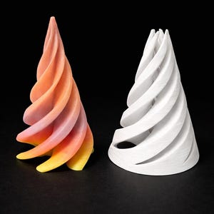 May include: Two abstract spiral sculptures. One is a gradient of yellow, orange, and pink. The other is white. Both have a conical shape with a series of curved, layered segments. The background is black.