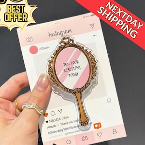 May include: A decorative mirror-shaped sticker with the text "YOU LOOK BEAUTIFUL TODAY" on a pink background. The sticker is set against a mock Instagram post background. A "BEST OFFER" and "NEXTDAY SHIPPING" banner are also visible.