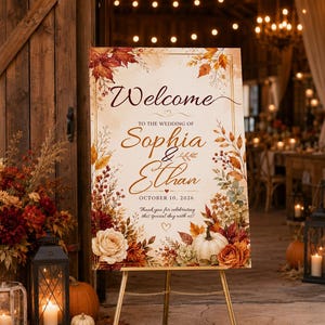 May include: A rectangular wedding welcome sign featuring autumn-themed floral illustrations, including orange and red leaves, berries, and white pumpkins. The text reads: Welcome to the wedding of Sophia & Ethan, October 10, 2026, Thank you for celebrating.