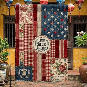 May include: A patriotic garden flag with a patchwork design resembling the American flag. The flag features red, white, and blue patterns, including stars, stripes, and floral prints. The text "GOD BLESS AMERICA" is displayed on a circular emblem. The flag is displayed outdoors.