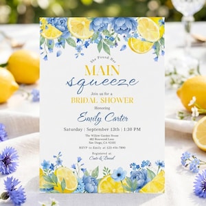 May include: A bridal shower invitation featuring a lemon and blue floral design. The invitation text reads "She Found Her Main Squeeze" and includes details for Emily Carter's shower. Yellow lemons and blue flowers decorate the invitation.
