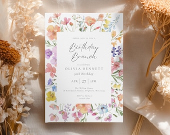 May include: A white invitation card with a floral border featuring pink, yellow, and purple flowers. The text reads "Birthday Brunch" to celebrate Olivia Bennett's 30th birthday on April 27th at 3 PM. The Willow House address is also included.