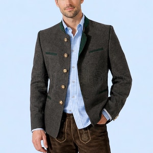 May include: A charcoal grey blazer with gold buttons and green trim. The blazer is worn over a light blue button-down shirt. The outfit includes brown leather trousers with decorative stitching. The blazer has a mandarin collar.