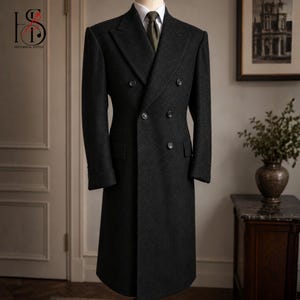 Peut inclure: Un pardessus croisé gris anthracite avec un design classique. Le manteau présente un revers cranté, plusieurs boutons et une coupe ajustée. Le manteau est présenté sur un mannequin. Le logo "HISTORICAL STITCH" est visible.