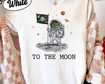 To The Moon Astronaut Frog Graphic Shirt, Funny Space Exploration Tee, NASA Artemis 2 Moon 2026 Humor Gift For Astronomy And Animal Lover