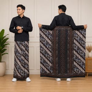 May include: A long-sleeved black button-down shirt paired with a floor-length sarong featuring a dark brown and black batik pattern with intricate white floral and diagonal line details. The sarong displays a central vertical panel of dark brown.