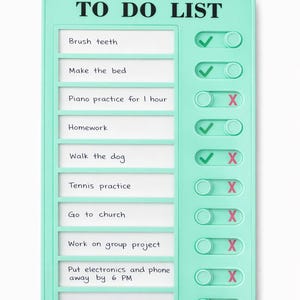 May include: A mint green plastic to-do list board with a rectangular frame. It features ten horizontal slots with white inserts displaying handwritten tasks like Brush teeth, Make the bed, and Piano practice, alongside sliding toggles with checkmarks and X symbols.