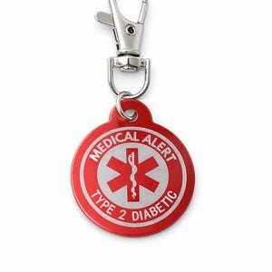 May include: A red and silver medical alert tag for Type 2 Diabetics. The round tag features the medical alert symbol and the words "MEDICAL ALERT" and "TYPE 2 DIABETIC". It is attached to a silver-colored clasp.