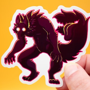 May include: A sticker featuring a stylized werewolf illustration in shades of purple and black, with glowing yellow eyes. The werewolf is in a dynamic pose, with a fluffy tail and sharp claws. The sticker has a white border and is held against a yellow background.