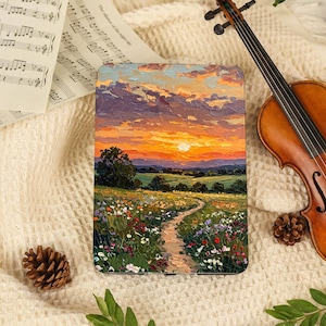 May include: A rectangular print featuring an oil painting of a sunset over a wildflower meadow with a winding dirt path. The scene includes a violin, sheet music, and pinecones arranged on a textured cream-colored fabric surface.