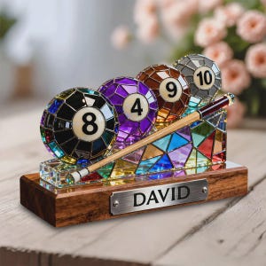 May include: A decorative billiards-themed display featuring four mosaic-style pool balls numbered 8, 4, 9, and 10. A cue stick rests on a colorful glass base, all set on a wooden stand with a metal plate that reads "DAVID".