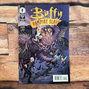 May include: A comic book titled "Buffy the Vampire Slayer" with a purple and black monster on the cover. The cover art features a blonde woman in a blue shirt and white shorts, and the text "Buffy the Vampire Slayer".