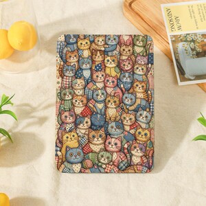 May include: A rectangular decorative plaque featuring a dense, colorful illustration of numerous cats in various patterns, colors, and poses. The cats are depicted with distinct facial expressions and are arranged in a tight, overlapping grid-like composition.