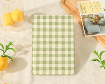 May include: A rectangular e-reader cover featuring a light green and white gingham check pattern. The cover has a smooth, matte finish and displays a consistent grid design across its entire surface, providing a clean and uniform appearance.