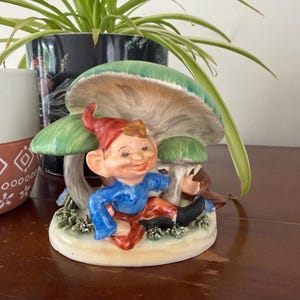 May include: A set of three ceramic nesting bowls in shades of blue, green, and white. The bowls have a speckled glaze and a simple, modern design. The largest bowl is about 15 cm in diameter.