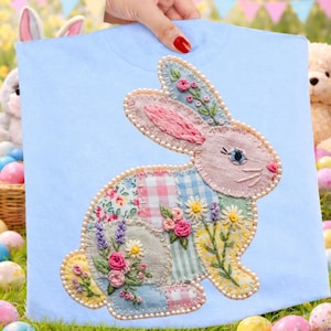 May include: A set of three ceramic mugs with a speckled, matte finish. The mugs are in shades of cream, light brown, and dark brown. Each mug has a simple, minimalist design and a rounded handle.