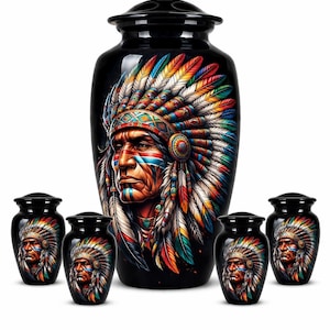 May include: Black urns featuring a Native American chief portrait. The large urn displays a detailed, colourful depiction of a chief in a feathered headdress. Smaller urns with the same design surround the larger one. The artwork is vibrant and detailed.