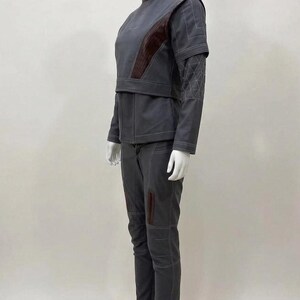 May include: A white ceramic mug with a black handle and the text "But First, Coffee" in a bold, black font. The mug is set against a neutral background, highlighting its simple design.