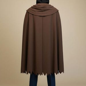 May include: A white ceramic mug with a black handle and the text "But First, Coffee" in a bold, black font. The mug is set against a neutral background, highlighting its simple design.