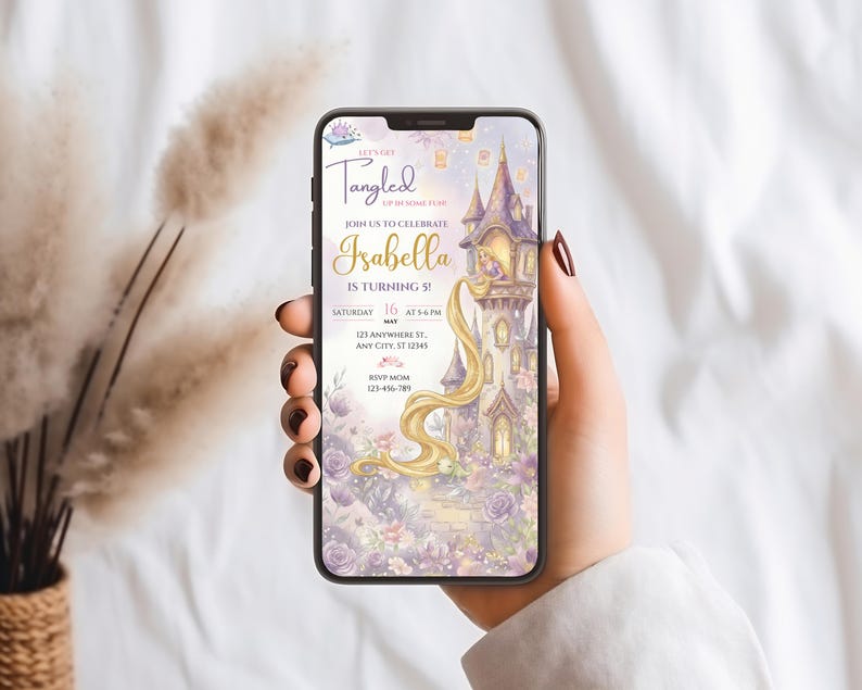 A person's hand holding a smartphone displaying a birthday invitation for a girl named Isabella.