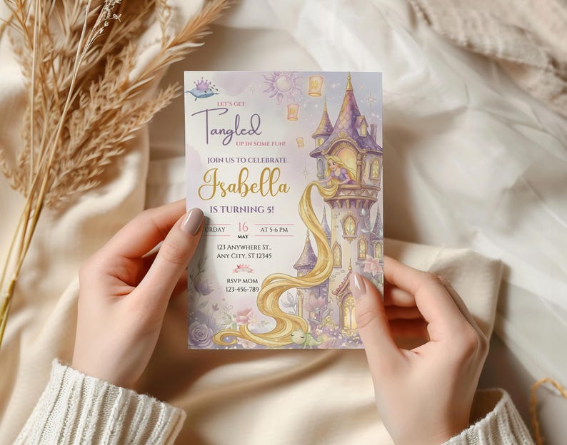 A person's hands holding a birthday invitation for a girl named Isabella, who is turning 5 years old.