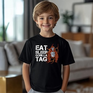 a young boy standing in front of a couch