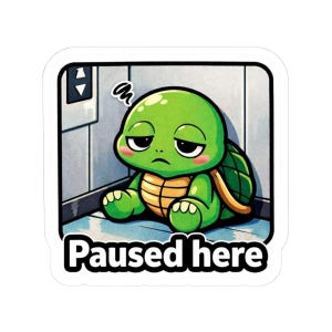 May include: A sticker featuring a cartoon turtle with a bored expression, sitting in a corner. The turtle is green with a yellow shell and pink cheeks. The text "Paused here" is written in bold, black letters at the bottom.