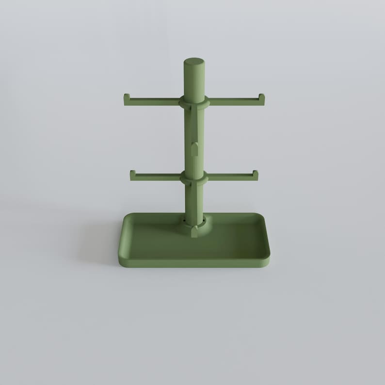 May include: A sage green mug tree with a rectangular base and three tiers of hooks for hanging mugs. The central pole is cylindrical, and the hooks extend horizontally. The design is minimalist and functional.