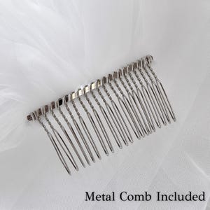 May include: A silver metal comb with twisted teeth is attached to a white veil. The comb is designed to secure the veil in place. The text "Metal Comb Included" is visible at the bottom of the image.
