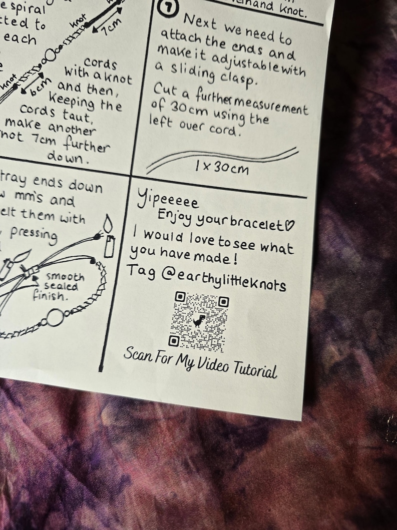 May include: A white instructional card with black ink illustrations and text detailing bracelet making steps. It includes a QR code labeled Scan For My Video Tutorial, a section for a 30 cm cord measurement, and the text Yipeeeee Enjoy your bracelet.