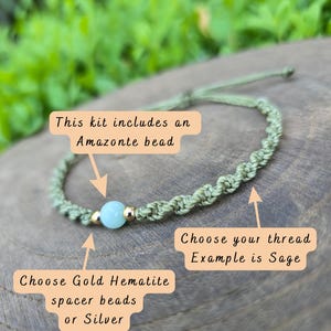 May include: A sage green macrame bracelet featuring a central light blue Amazonite bead flanked by two gold-colored hematite spacer beads. The text on the image reads: This kit includes an Amazonite bead, Choose your thread Example is Sage, Choose Gold Hematite spacer beads or Silver.