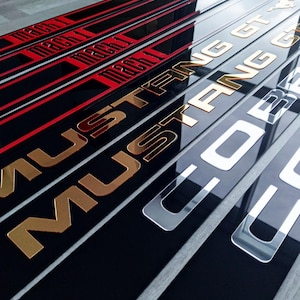 May include: A rustic wooden sign with the text "Welcome to our home" in a handwritten style. The sign features a distressed finish and a simple, inviting design, perfect for a front porch or entryway.