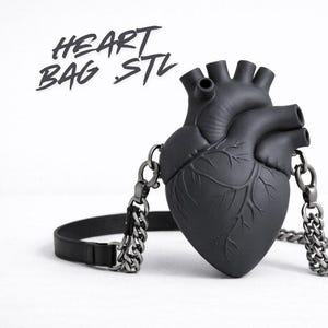 May include: A black heart-shaped bag with a chain strap and a leather strap. The bag has a detailed anatomical design and the text "HEART BAG STL" in a handwritten font.