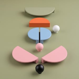 May include: A collection of cabinet hardware including several semi-circular drawer pulls in sage green, orange, light blue, and pink, alongside three spherical knobs in white, light pink, and black, arranged in a symmetrical pattern.