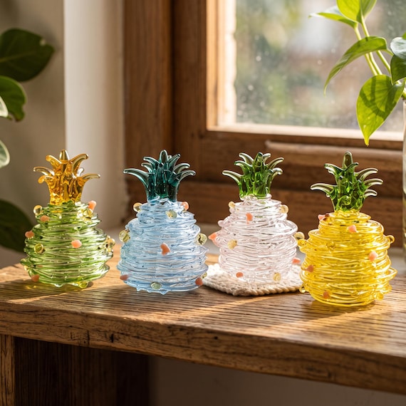 A vibrant, multicolored hand-blown glass pineapple figurine that brings serious coastal craft energy — genuinely hard to find this quality.